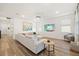 Spacious living room with a large sofa, decorative art, and ample natural light at 11221 Gallatin Trl, Parrish, FL 34219