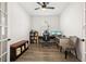Well-lit office space with a spacious desk, shelving, and comfortable seating at 11221 Gallatin Trl, Parrish, FL 34219