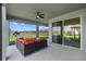 Screened patio with outdoor seating overlooking a tranquil lake view at 11221 Gallatin Trl, Parrish, FL 34219