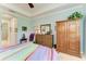 Bedroom featuring a decorative bureau and a view of the ensuite bath through an arched doorway at 116 Pescador Pl, Nokomis, FL 34275