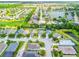 Bird's-eye view of the community with mature trees, scenic lakes, and well-maintained homes and streets at 11790 Fennemore Way, Parrish, FL 34219