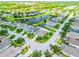 Aerial view of a residential area with a serene lake, showcasing the neighborhood layout and proximity to water at 11790 Fennemore Way, Parrish, FL 34219
