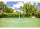 Community basketball court with a green surface and manicured hedge border at 11790 Fennemore Way, Parrish, FL 34219