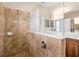 Bathroom featuring decorative tile shower and dual sinks at 11790 Fennemore Way, Parrish, FL 34219