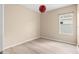 Bright bedroom featuring white walls, a modern light fixture, and a large window for natural light at 11790 Fennemore Way, Parrish, FL 34219