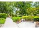 Community sidewalk with a bike rack and lush greenery in the background at 11790 Fennemore Way, Parrish, FL 34219