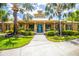 Community clubhouse featuring tropical landscaping, covered porch and blue door at 11790 Fennemore Way, Parrish, FL 34219