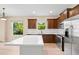 Bright modern kitchen with stainless steel appliances, dark wood cabinets, and a white kitchen island at 11790 Fennemore Way, Parrish, FL 34219