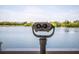 Binoculars offering panoramic views of the tranquil lake and lush landscape, for an immersive outdoor experience at 11790 Fennemore Way, Parrish, FL 34219