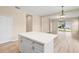 Open-concept living area featuring sleek countertops, ample cabinetry, and an abundance of natural light at 11790 Fennemore Way, Parrish, FL 34219