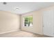 Bright living space featuring wood flooring, a window and a white entry door at 11790 Fennemore Way, Parrish, FL 34219