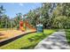 Playground with slides and swings, located near a walking path and community sign at 11790 Fennemore Way, Parrish, FL 34219