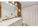Well-lit bathroom boasts a spacious vanity with modern fixtures and a shower with a white curtain at 1248 Jefferson Dr, Englewood, FL 34224