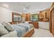Bedroom with wood paneling, tiled floor, and two windows at 1248 Jefferson Dr, Englewood, FL 34224