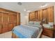 Comfortable bedroom featuring wood paneling, a ceiling fan, and a closet with natural light at 1248 Jefferson Dr, Englewood, FL 34224