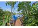 Charming dock with colorful chairs, offering a peaceful waterfront retreat amidst lush foliage at 1248 Jefferson Dr, Englewood, FL 34224