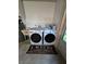Functional laundry room features new Samsung washer/dryer, utility sink, and convenient door at 1248 Jefferson Dr, Englewood, FL 34224