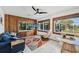 Comfortable living room with wood paneling, tiled floor, and plenty of natural light at 1248 Jefferson Dr, Englewood, FL 34224