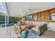 Inviting covered patio with ample seating, ceiling fans, and a mounted TV for entertainment at 1248 Jefferson Dr, Englewood, FL 34224