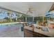 Spacious, covered patio with pool, seating area, ceiling fans, and TV for relaxation and entertainment at 1248 Jefferson Dr, Englewood, FL 34224