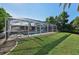An inviting in-ground pool featuring an enclosed screened lanai in the landscaped backyard at 1248 Jefferson Dr, Englewood, FL 34224