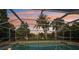 Tranquil screened-in pool area with lush tropical landscaping, providing a private outdoor oasis at 1248 Jefferson Dr, Englewood, FL 34224
