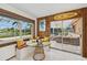 Cozy sunroom with table, bench seating, and a view of outdoor lounge area at 1248 Jefferson Dr, Englewood, FL 34224