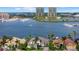 Stunning aerial view of waterfront homes, including a white home with a tile roof and lush palm trees and a view of the marina at 125 12Th E Ave, Palmetto, FL 34221