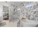 Luxurious bathroom with soaking tub, glass enclosed shower, and marble tiling at 125 12Th E Ave, Palmetto, FL 34221