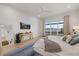 Bedroom showcasing a waterfront view, light hardwood floors, and a modern ceiling fan at 125 12Th E Ave, Palmetto, FL 34221