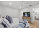 A bedroom with white walls, hardwood floors, a TV, and a comfortable bed with throw pillows at 125 12Th E Ave, Palmetto, FL 34221