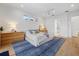 Well-lit bedroom featuring light hardwood floors, a white ceiling, and a modern ceiling fan at 125 12Th E Ave, Palmetto, FL 34221