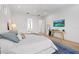 Bright bedroom with a TV, hardwood floors, and views to an adjoining bathroom and walk-in closet at 125 12Th E Ave, Palmetto, FL 34221