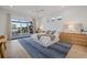 Bright bedroom featuring a waterfront view, hardwood floors, and a stylish blue area rug at 125 12Th E Ave, Palmetto, FL 34221