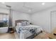 Cozy bedroom with natural light, a comfortable bed with blue accents, and hardwood floors at 125 12Th E Ave, Palmetto, FL 34221