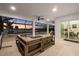 Inviting covered patio with comfortable seating, ceiling fans, and sunset water views at 125 12Th E Ave, Palmetto, FL 34221
