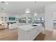 Open-concept kitchen with a large island and a view of the living room and waterfront at 125 12Th E Ave, Palmetto, FL 34221