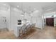Modern white kitchen with island seating, stainless steel appliances, and open layout at 125 12Th E Ave, Palmetto, FL 34221