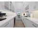Modern butler's pantry with white cabinets, countertops, and water view at 125 12Th E Ave, Palmetto, FL 34221