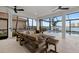 Inviting lanai featuring a pool, comfortable seating, and stunning waterfront views at 125 12Th E Ave, Palmetto, FL 34221