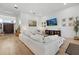 Bright living room with hardwood floors, recessed lighting, and featuring a large sectional sofa and a modern media center at 125 12Th E Ave, Palmetto, FL 34221