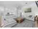 Open-concept living room with white sofas and seamless flow into the modern kitchen area at 125 12Th E Ave, Palmetto, FL 34221