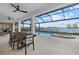 Screened patio with dining area, built-in bar, and a stunning waterfront view and pool at 125 12Th E Ave, Palmetto, FL 34221