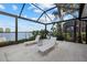Relaxing waterfront patio with comfortable lounge chairs, lush landscaping, and direct water access at 125 12Th E Ave, Palmetto, FL 34221