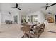Spacious patio with an outdoor kitchen, dining area, and comfortable seating beneath modern ceiling fans at 125 12Th E Ave, Palmetto, FL 34221