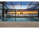 Beautiful pool with screened enclosure offering stunning sunset views of the water and marina at 125 12Th E Ave, Palmetto, FL 34221
