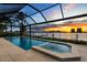 Inviting pool and spa with a screened enclosure and views of the water and marina at 125 12Th E Ave, Palmetto, FL 34221