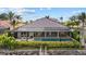 A beautiful waterfront home featuring a private screened-in pool with an attached spa and lush landscaping at 125 12Th E Ave, Palmetto, FL 34221