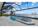 Breathtaking waterfront pool and spa area, enclosed with a screen, offering stunning views of the water at 125 12Th E Ave, Palmetto, FL 34221