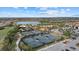 Aerial view of the community's tennis courts and lake, showcasing the recreational amenities and scenic views at 12659 Sorrento Way, Bradenton, FL 34211